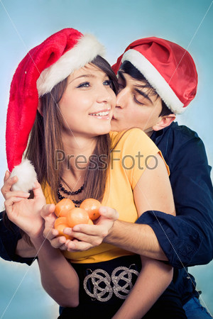 man surprising woman with tangerine