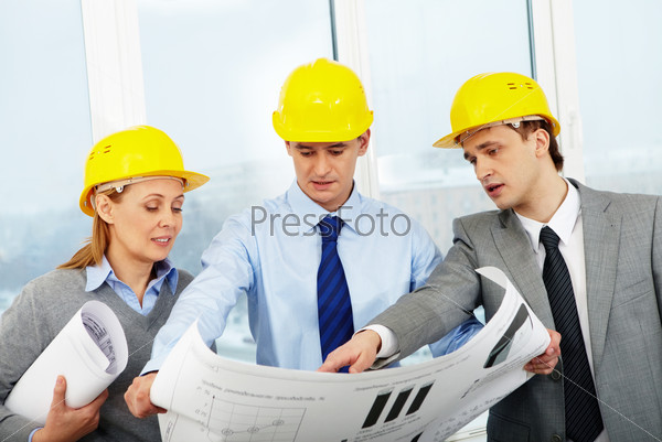 Three architects looking at a project and discussing it