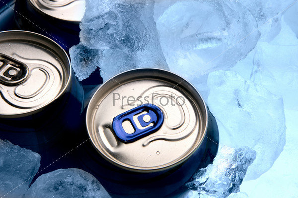 Three aluminium cans of beer and ice