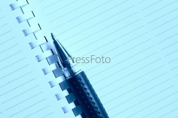 Blank notebook page and pen toned in blue color, stock photo