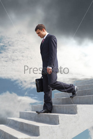Image of sad businessman walking downstairs