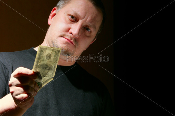 Man offering money over black background with space for your own text on right, stock photo