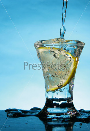 Short glass of alcoholic beverage with lemon slice