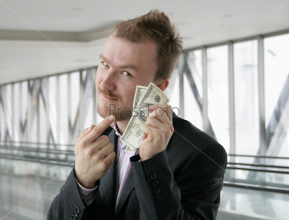 Young man point to money in his hand, stock photo