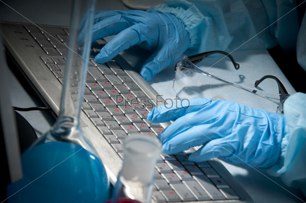 Scientific officer working on computer in laboratory environment