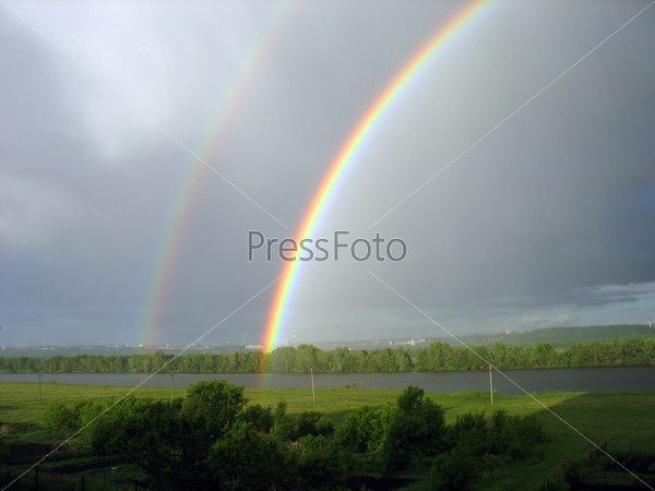 landscape with rainbow over lake after storm