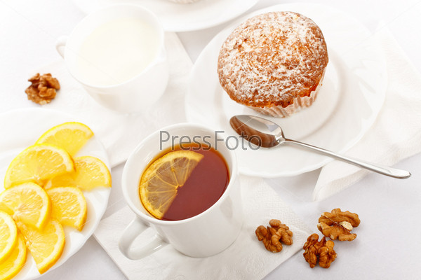 tea with lemon and fancy cakes, still life