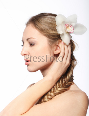 Portrait of the beauty young blond girl with orchid in her hair