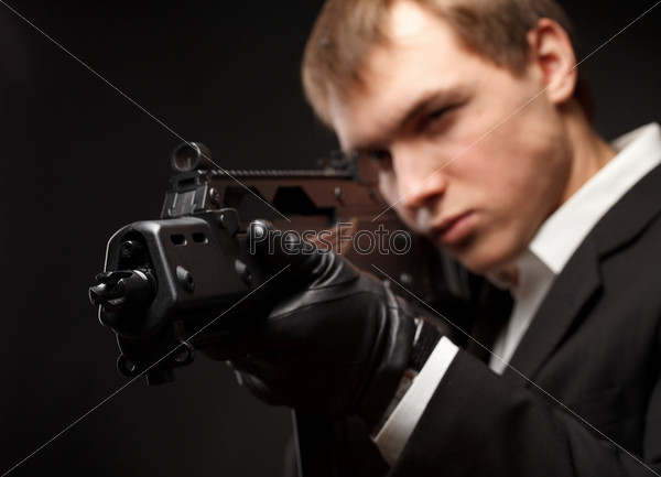 Man with gun over gradient gray
