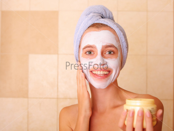 Beautiful woman puts on the face a mask
