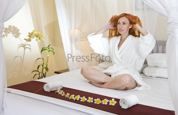 Woman in house clothes on a bed