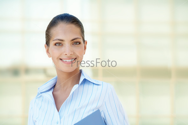 Portrait of pretty employee smiling at camera