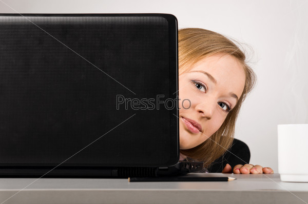 woman is looking out of laptop at office