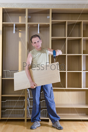 Man is engaged in repair and furniture