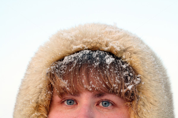 woman\'s blue eyes and hair under snow