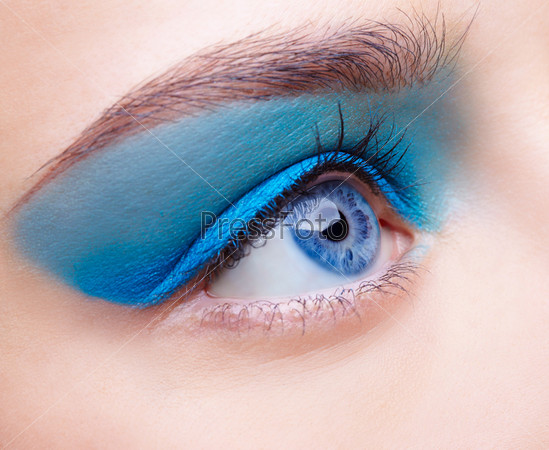 close-up portrait of beautiful girl\'s eye-zone make-up with blue eye shadows