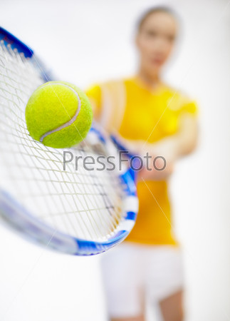 Tennis tournament - player woman with tennis racket and ball  Low-focus shot with focus on tennis ball