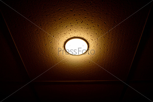 One lamp on the ceiling isolated on black, stock photo