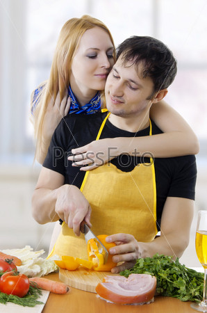 young loving couple embracing face to face in kitchen