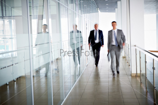Business People Walking In The Office Corridor