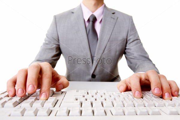 Close-up of businessman sitting at the table and typing
