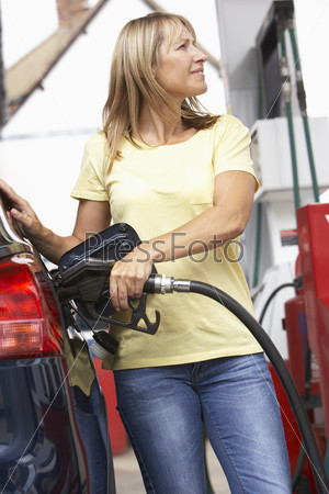 Detail Of Female Motorist Filling Car With Diesel At Petrol Station
