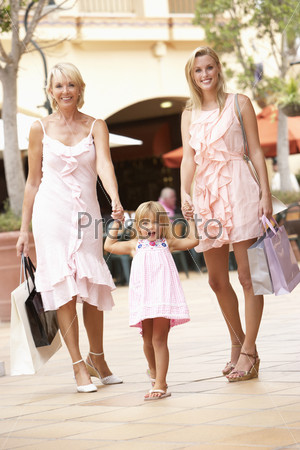 Grandmother, Mother And Daughter Enjoying Shopping Trip Together