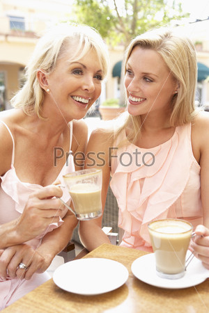 Two Women Enjoying Cup Of Coffee In Caf