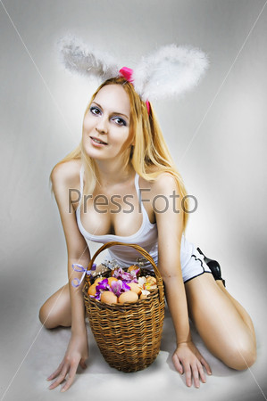 Sexy woman easter bunny with basket of eggs