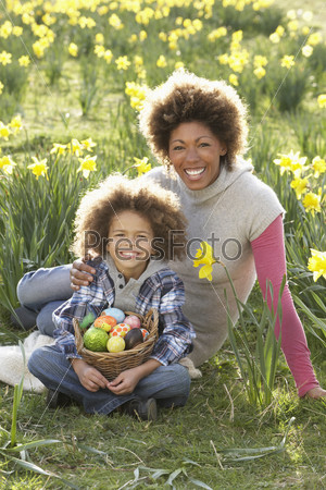 Mother And Son On Easter Egg Hunt In Daffodil Field