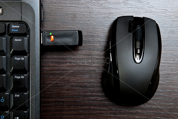 Black mouse and notebook. Wireless technology, stock photo