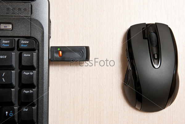 Black mouse and notebook. Wireless technology