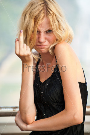 Beautiful young caucasian blond showing her middle finger