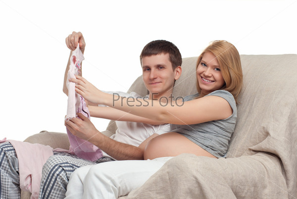 Couple choosing baby s clothes