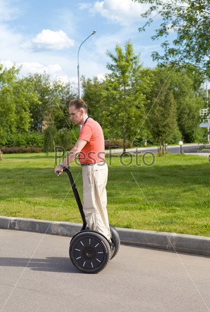 A man on an electric scooter-Segway .