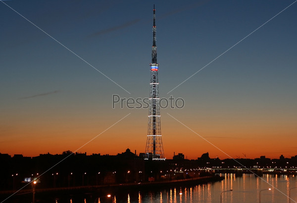 Television tower of St. Petersburg. Sunset over the city. Gradient of bright colors. Sharp line of city roofs.