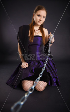 Young beautiful girl pulls out a chain leash