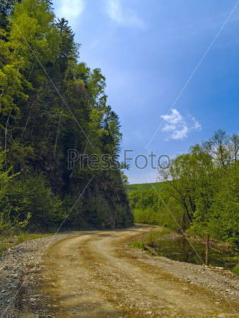 The Year landscape a tumbling of road beside declivity of mountain, stock photo