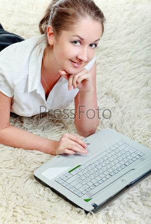 woman laying on floor with laptop computer