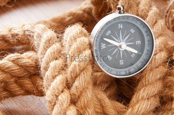 Compass and rope in travel and adventure concept