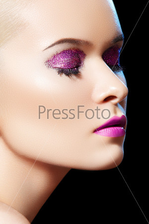 Fashionable close-up portrait of glamour woman model with winter glitter evening make-up, purity complexion. Sensual beauty model with shiny glitter make-up