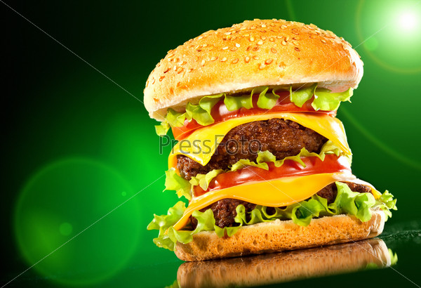 Tasty hamburger and french fries on a dark background, stock photo