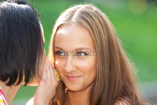 Two beauty woman talk a secret