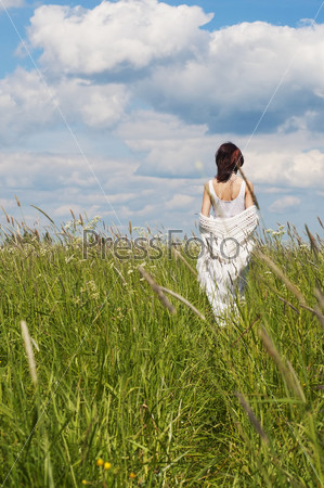 Rural scene. Day summer time. Back of the woman in a white dress, stock photo