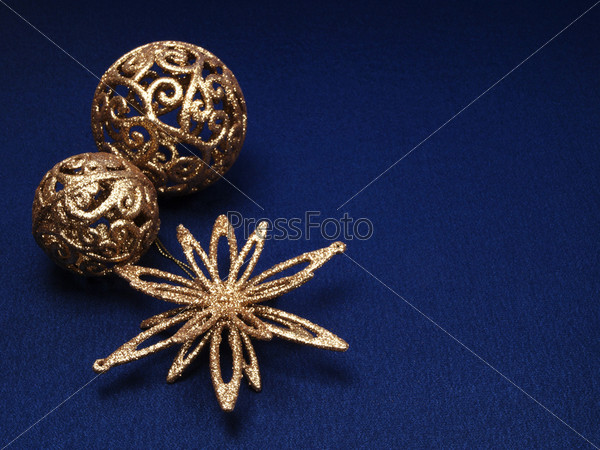 Christmas background of dark blue color with gold decorations for a fir-tree