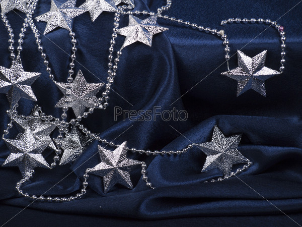 Christmas background of dark blue color with a pattern from silver stars, stock photo