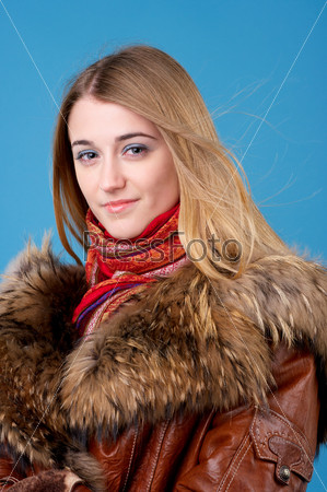 Portrait of beautiful female in sheepskin coat with fur collar