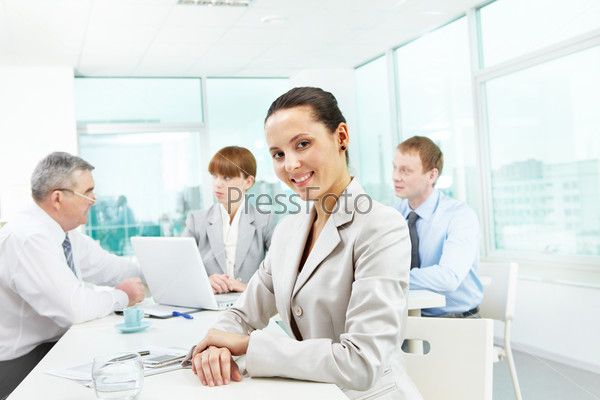 Portrait of smart employer looking at camera in working environment