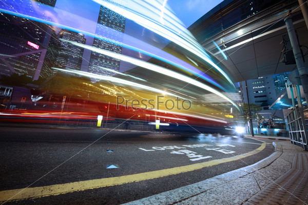 Bus speeding through night street. Hong Kong, China.