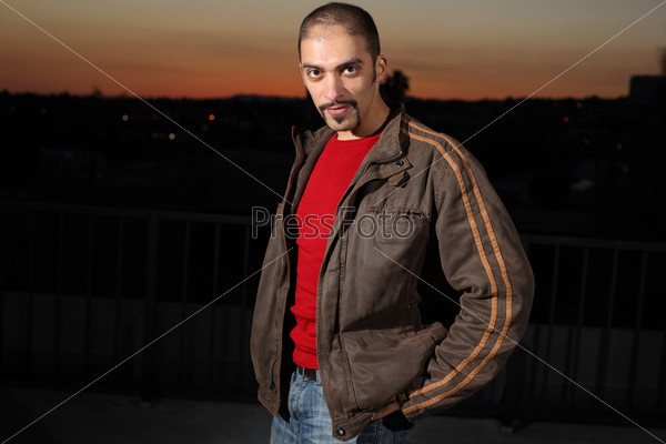 Portrait of a handsome man in brown jacket outdoors